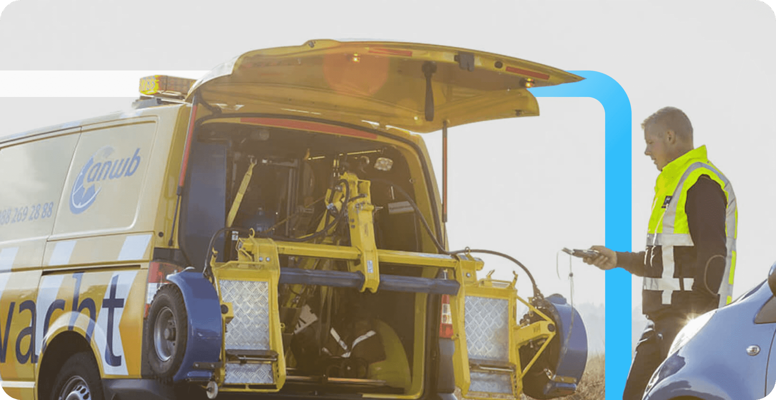 An ANWB roadside assistance technician in a high-visibility vest checks a device beside an open yellow service van.