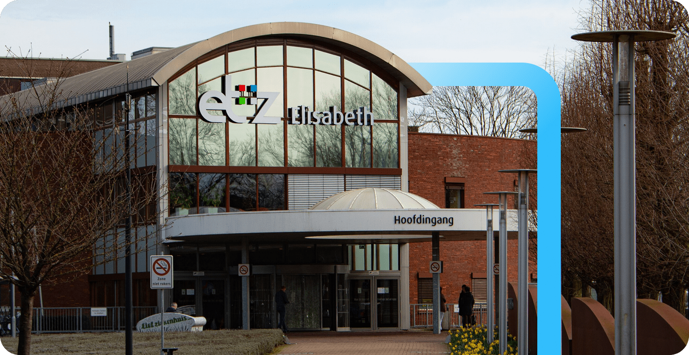 Main entrance (Hoofdingang) of the ETZ Elisabeth hospital featuring a large arched glass facade and domed canopy.