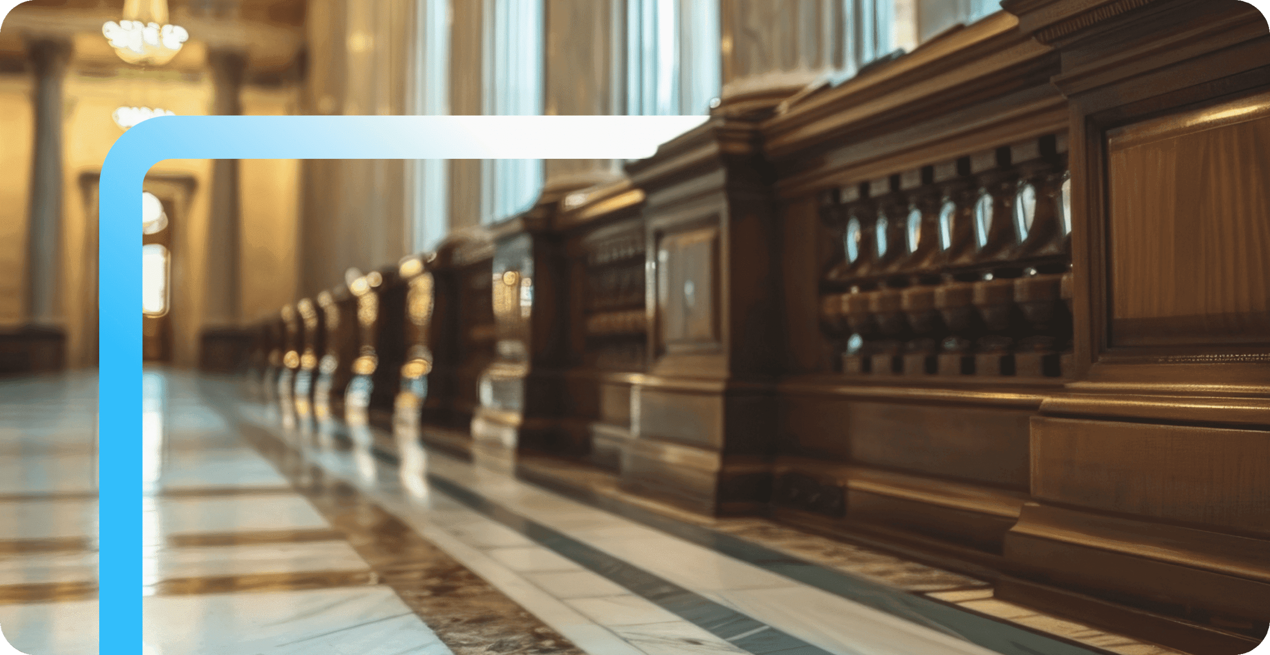 Ornate wooden balustrades line a polished marble hallway inside a grand government building with chandeliers.