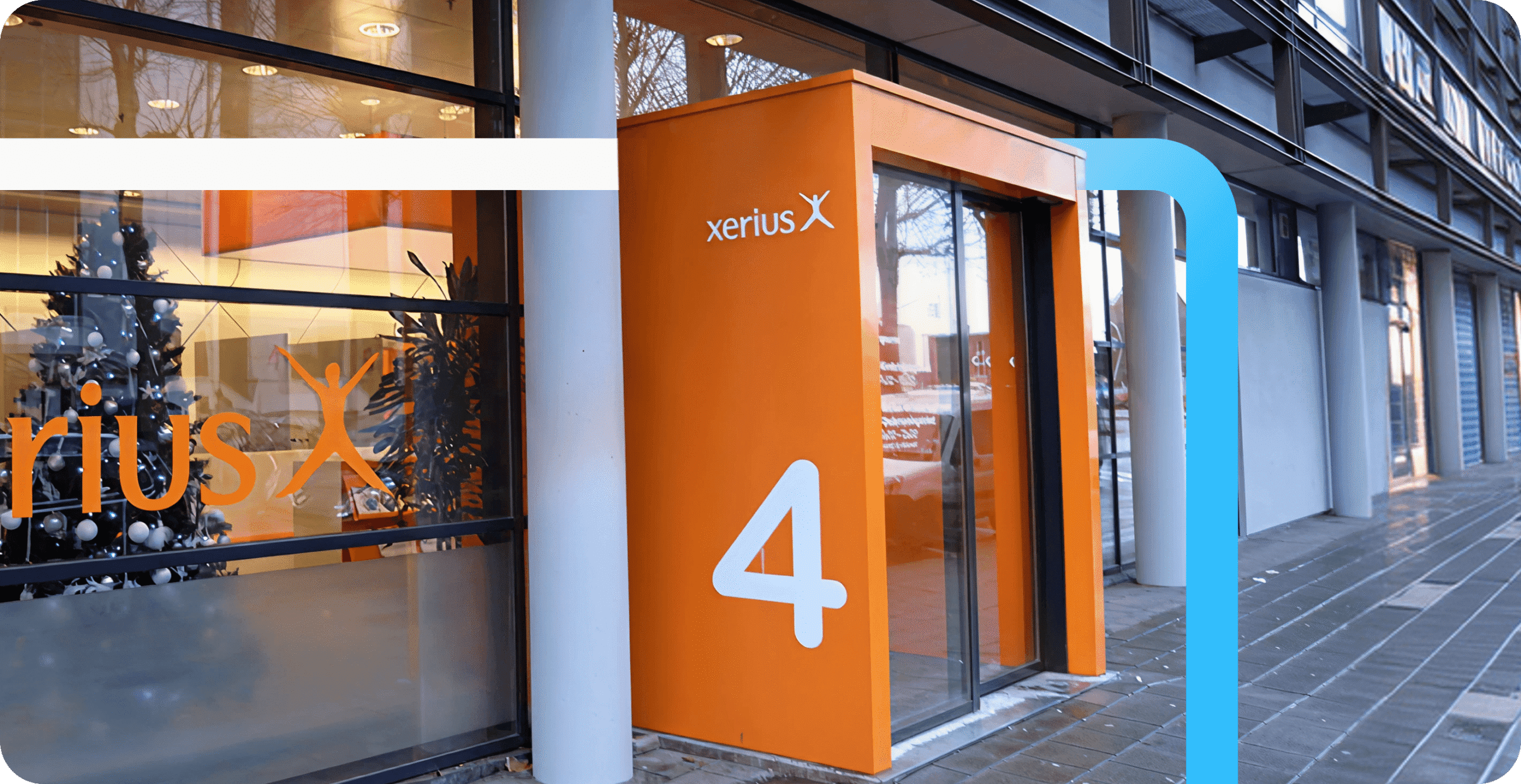 Xerius office entrance featuring a bold orange doorway with the number 4 and company logo on the glass facade.