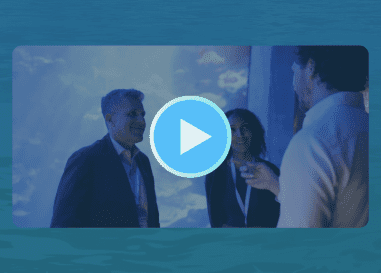 Video thumbnail of three professionals networking at a Salesforce event with a play button overlay.