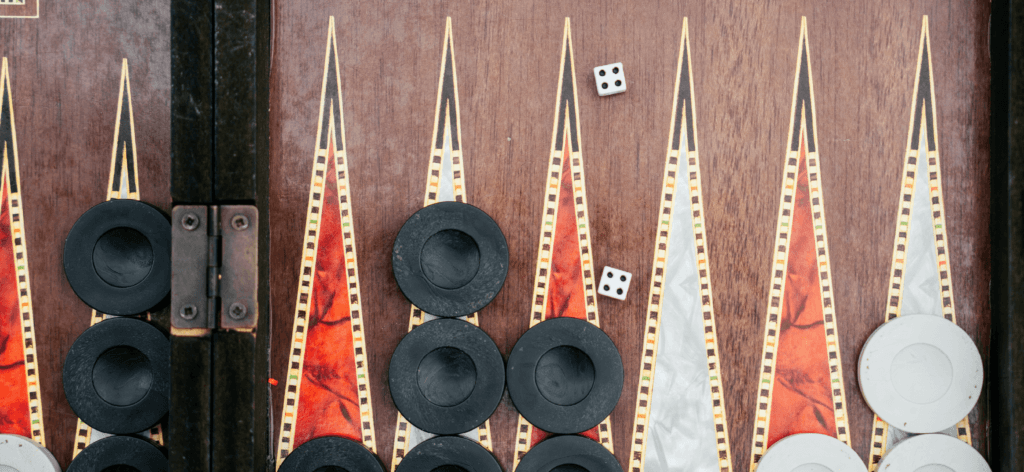 Image shows a board game with dice and discs